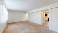 Located at 1580 Prospect Street in Elyria, Ohio, this two-story home offers three bedrooms and two bathrooms across a well-organized floor plan. The main level hosts two living areas, a kitchen, and connecting hallways, while the upper level accommodates the bedrooms and additional living space. Throughout the home, neutral-toned carpeting provides a warm and consistent feel.

The kitchen is appointed with rich, dark cabinetry offering generous storage, light-toned countertops, a dishwasher, gas range, and refrigerator. Stone-look tile flooring grounds the space, and a window above the sink allows for natural light.

The living areas are open and airy, with clean white walls and a sliding glass door in one room that fills the space with natural light and provides outdoor access. Six-panel interior doors and textured ceilings are consistent design elements throughout.

The generously sized primary bedroom features a ceiling fan with lighting, a window for natural light, and a large closet with bifold doors and a clothing rod. The additional bedrooms are well-proportioned and carpeted.

The bathroom includes a tiled tub-shower combination, wainscoting, stone-look tile flooring, and a window that brings in natural light. Hallways connect each level efficiently, and a staircase links the two floors seamlessly.
