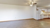 Located at 3420 Mason Rd in Burlington, Iowa, this single-floor unit offers three bedrooms and two bathrooms within a thoughtfully arranged floor plan. The combined kitchen and living area forms the heart of the home, with the living room featuring durable hardwood-style flooring, a ceiling fan with integrated lighting, and neutral white walls that create a clean, bright atmosphere. A large window in the living area allows natural light to flow in, offering views of the surrounding grounds.

The kitchen is well-appointed with abundant white cabinetry trimmed in warm wood tones, light countertops, a double sink with dishwasher, and a range — providing ample workspace and storage for everyday cooking needs.

Each of the three bedrooms is carpeted for comfort and includes its own closet with built-in shelving or hanging rods, offering practical storage solutions. The bedrooms maintain a consistent, neutral palette that makes them versatile and easy to personalize.

The two bathrooms are finished with hardwood-style flooring. One features a walk-in shower with a glass enclosure and a vanity with under-sink cabinetry, while the other includes a full bathtub and additional built-in shelving. Warm wood-tone doors and trim are consistent throughout, tying the overall aesthetic of the unit together cohesively.