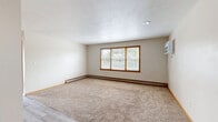 Located at 1016 Lincoln Rd in Bettendorf, Iowa, this single-floor residence offers three bedrooms and one full bathroom within a compact, efficiently organized layout. The interior features a neutral color palette with cream-toned walls and warm wood-trimmed doors and baseboards throughout, creating a cohesive and understated aesthetic.

The bedrooms are carpeted and well-proportioned, each equipped with sliding wood-panel closet doors for convenient storage. The generously sized primary bedroom features a sliding glass door opening to a private balcony that overlooks lush greenery, bringing in natural light and outdoor views. Additional bedrooms include windows with wood-framed blinds, allowing for natural light. Baseboard heating runs along the perimeter of the rooms, ensuring consistent warmth throughout.

The shared living area transitions from carpet to wood-look vinyl flooring and includes a ceiling fan, wall-mounted air conditioning unit, and entry closet storage. The full bathroom is finished with white tile walls, a single-sink vanity with cabinet storage, a toilet, and a tub/shower combination with a decorative curtain. The wood-look vinyl flooring in the bathroom adds a modern touch. Overall, the space presents a practical and comfortable layout suited for everyday living.