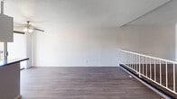 Located in the Beverly Grove neighborhood of Los Angeles, this single-floor unit at 320 S Arnaz Drive offers a clean and functional layout with modern finishes throughout. The open living area is spacious and bright, featuring durable hardwood-style flooring, crisp white walls, and a textured ceiling. A ceiling fan provides comfortable airflow, while a sliding glass door floods the space with natural light and leads out to a private balcony with open city views — an ideal spot to enjoy the Southern California atmosphere.

The kitchen is efficiently designed with white cabinetry, dark granite countertops, a stainless steel refrigerator, and a sliding glass door that provides direct balcony access and additional natural light. The layout allows for easy flow between cooking and living spaces.

The bathroom is thoughtfully appointed with a dark granite vanity countertop, white cabinetry with ample storage, a medicine cabinet with mirror, and a separate water closet containing a tub-shower combination and toilet — offering a practical and organized layout.

Throughout the unit, the consistent use of hardwood-style flooring, neutral tones, and clean finishes creates a cohesive and move-in-ready aesthetic well-suited to the vibrant Los Angeles lifestyle.
