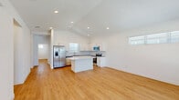 Located in Weatherford, TX, this single-story home offers four bedrooms and four bathrooms within a thoughtfully designed floor plan. The open-concept kitchen and living area serves as the heart of the home, highlighted by soaring vaulted ceilings with recessed lighting and warm luxury vinyl plank flooring that flows throughout. The kitchen is well-appointed with white shaker cabinetry, dark countertops, a subway tile backsplash, a central island with a white quartz surface, and a full suite of stainless steel appliances including a French door refrigerator, range, microwave, and dishwasher. The living area benefits from large windows that invite abundant natural light and views of the surrounding neighborhood. Each bedroom is finished with the same durable plank flooring, ceiling fans, and ample natural light. The spacious primary bedroom is complemented by a generously sized walk-in closet with built-in shelving. The bathrooms feature white cabinetry, quartz countertops, and a clean, modern aesthetic. A dedicated hallway connects the private quarters of the home. Outside, a fully fenced backyard provides a low-maintenance retreat with artificial turf, a gravel section, and a concrete patio — ideal for outdoor enjoyment in the Texas climate.