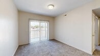 Located at 3544 W 6200 S in Taylorsville, Utah, this single-floor, 2-bedroom, 1-bathroom unit offers a practical and efficiently organized layout. The unit's overall footprint is compact yet thoughtfully arranged to maximize usability across all rooms.

The kitchen features warm oak cabinetry with ample upper and lower storage, light-toned countertops, a double-basin sink, and white appliances including a range, microwave, and dishwasher. Wood-look vinyl flooring adds durability to the space. A hallway connects the kitchen and living areas to the bedrooms, bathroom, and utility room, contributing to a logical flow throughout.

The primary bedroom is a well-sized space featuring plush carpeting, neutral wall tones, and a sliding glass door with vertical blinds that allows natural light and outdoor views. It also includes a closet with double doors and a full-width hanging rod. The second bedroom is similarly carpeted and bright, featuring a window with horizontal blinds that brings in natural light.

The bathroom includes a wood-toned vanity with a single sink, a wall mirror, and a full tub-shower combination with chrome grab bar, set on wood-look vinyl flooring. A utility room provides additional functional space within the unit.