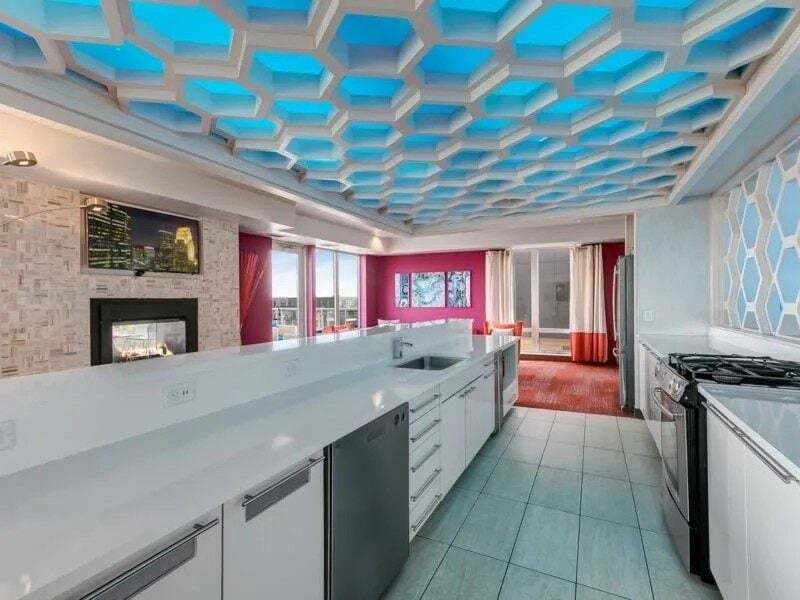Modern kitchen with a honeycomb ceiling and a fireplace.