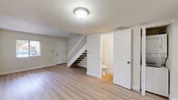 Located at 8300 NW Seventh St in Miami, FL, this two-story, two-bedroom, three-bathroom home offers a well-organized layout spread across two floors. Light wood-style flooring runs throughout, creating a clean, cohesive aesthetic. The ground floor features a bright living area with natural light from windows with vertical blinds, a hallway, and a conveniently located bathroom tucked beneath the staircase. The staircase itself features a white balustrade with warm wood treads, serving as a subtle design detail. The kitchen is equipped with stainless steel appliances—including a refrigerator, electric range, dishwasher, and range hood—complemented by modern wood-tone cabinetry and granite-style countertops. The upper floor houses both bedrooms, additional bathrooms, and laundry. The primary bedroom offers a generous footprint with a closet and natural light from an exterior-facing window. The bathrooms are finished with tile-surround tub-shower combos, wood-tone vanities with updated hardware, and mirrors. With four closets distributed throughout, storage is plentiful. The home's neutral color palette and updated finishes give it a fresh, move-in-ready feel.