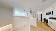 Located at 11130 Vida Cir in Bradenton, FL, this well-designed one-bedroom, one-bathroom residence offers a thoughtfully organized layout that maximizes its comfortable footprint. Light wood-style flooring runs throughout the entire space, creating a cohesive and airy feel from room to room.

The open-concept kitchen and living area serves as the heart of the home. The kitchen is outfitted with crisp white shaker-style cabinetry extending to the ceiling, quartz countertops, and a full suite of stainless steel appliances including a refrigerator, range, microwave, and dishwasher. A large central island with a built-in sink and pendant lighting above provides additional workspace and a natural gathering point. The adjoining living area features a ceiling fan and multiple windows that invite abundant natural light, with a glass door providing direct outdoor access.

The spacious primary bedroom comfortably accommodates a full bedroom suite and is brightened by dual windows with outdoor views and its own ceiling fan. A dedicated closet offers organized storage. The bathroom features a white vanity with quartz countertop, clean tile work, and a well-planned layout with access to both the hallway and closet. A hallway connects all areas of the home efficiently, completing this clean and modern residence.