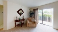 Located in the Christiana Meadows community of Bear, Delaware, this single-floor residence offers a well-organized and comfortable layout designed for easy living. The expansive living room is carpeted and filled with natural light, courtesy of large sliding glass doors that open to an outdoor view, creating a bright and welcoming atmosphere. Adjacent to the living room, the dedicated dining area provides a defined space for meals, finished with the same neutral carpet and warm, cream-toned walls throughout. The kitchen is efficiently laid out in a U-shape configuration, featuring warm oak cabinetry, dark countertops, black appliances including an electric range and dishwasher, a single-basin sink, and a window that brings in additional natural light. The primary bedroom is generously sized with soft carpeting, a large window with an outdoor view, and ample wall space. The second bedroom also offers comfortable proportions with carpet flooring and a built-in closet. Both bathrooms are full baths, each equipped with a tub-shower combination. One bathroom features a wood-toned vanity with a wide mirror and overhead lighting. The home presents a clean, neutral palette throughout, making it a versatile and move-in-ready space.