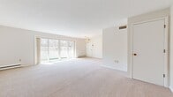 Located at 4601 Glenwood Park Ave in Erie, PA, this 2-bedroom, 2-bathroom single-floor residence offers a bright and well-organized layout with over 1,200 square feet of living space. The expansive living and dining area is bathed in natural light, courtesy of large sliding glass doors that open to a private balcony overlooking a wooded landscape. A classic chandelier adds a touch of elegance, while plush neutral carpeting runs throughout the main living spaces and bedrooms.

The kitchen is efficiently designed with warm oak cabinetry extending to the ceiling for ample storage, light-toned countertops, tile flooring, and a full suite of appliances including a refrigerator, electric range, and over-the-range microwave.

The generously sized primary bedroom features a wide picture window framing tranquil views of the surrounding trees, along with baseboard heating and plentiful closet space. The second bedroom is equally well-proportioned with a window and its own baseboard heating.

Both bathrooms are finished in clean white tones, featuring white shaker-style cabinetry, solid-surface countertops, large vanity mirrors, and tile accents. The second bathroom includes a full tub-shower combination. The overall ambiance is calm, clean, and move-in ready.