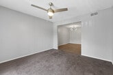 This single-floor, 2-bedroom, 2-bathroom residence in Birmingham, Alabama offers a well-organized layout designed for comfortable everyday living. The living room features plush carpeting and a ceiling fan, opening directly into a dedicated dining area accented by a stylish chandelier and wood-look flooring that extends throughout the main living spaces. The kitchen is thoughtfully appointed with white shaker-style cabinetry, light quartz countertops, a subway tile backsplash, stainless steel appliances including a dishwasher and refrigerator, and a breakfast bar that connects to the dining and living areas. A pantry provides additional storage, and an in-unit laundry room adds everyday convenience. Both bedrooms are carpeted and finished in neutral tones, with the primary bedroom offering a generous footprint and direct access to its own bathroom. The two bathrooms are clean and functional, each featuring wood-look tile flooring, white vanities with light countertops, and well-lit mirrors. One bathroom includes a full soaking tub and shower combination. A hallway connects the private bedroom wing to the main living areas, and two closets offer ample storage throughout the home.