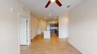 Located at 1910 Waycrest Dr SW in South Fulton, GA, this 2-bedroom, 2-bathroom single-floor home offers a well-designed layout with a bright, open feel throughout. The heart of the home is a combined living, dining, and kitchen area that flows seamlessly together. The kitchen is a standout feature, equipped with stainless steel appliances including a refrigerator, range, and over-the-range microwave, complemented by dark taupe cabinetry, light quartz-style countertops, a tiled backsplash, and a central island with a sink — ideal for both cooking and casual dining. Recessed lighting and a ceiling fan add to the functional ambiance of this shared space, which also benefits from a window bringing in natural light from the living area end. Light wood-look plank flooring runs throughout the home, creating a cohesive and easy-to-maintain aesthetic. Both bedrooms are comfortably sized, with the primary bedroom offering dedicated closet access and a ceiling fan. The second bedroom features a large window with exterior views. Each of the two bathrooms includes a tub-shower combination, a single-sink vanity with cabinet storage, and matching light flooring. Four closets provide ample storage throughout the home.