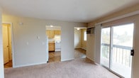 Located at 1905 West Appleway Avenue in Coeur d'Alene, Idaho, this single-floor unit offers a practical and comfortable layout suited for everyday living. The living area is generously sized, featuring soft carpeting, neutral warm-toned walls, and a sliding glass door that opens to a private balcony with open outdoor views — allowing natural light to fill the space. Baseboard heating runs throughout the unit, ensuring consistent warmth.

The kitchen is thoughtfully laid out with light wood cabinetry offering ample storage, laminate countertops, and white appliances including a refrigerator, electric range, and dishwasher. A pendant light above the sink adds a functional accent to the space, and durable tile-style flooring completes the kitchen area.

The bedrooms are carpeted and finished with the same neutral palette, each featuring a window that brings in natural light and baseboard heating beneath. The spaces are clean and well-proportioned, offering a comfortable retreat.

The bathroom includes a combined tub and shower unit, a vanity with countertop storage, and tile flooring, providing a clean and efficient layout. Overall, the unit presents a straightforward, move-in-ready living environment in a convenient Coeur d'Alene location.