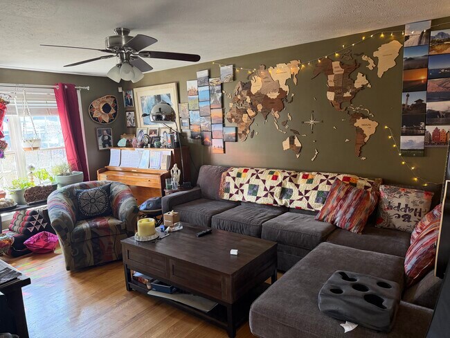 Living room, sofa, piano, and rising coffeetable, 55” tv, included in rental - 207 Pasture Dr