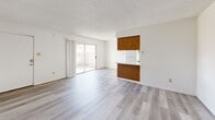 This 520 square foot apartment in Bakersfield, CA offers a well-designed living space with modern updates. The single-story layout maximizes efficiency, featuring an open-concept living and kitchen area. The kitchen showcases wooden cabinetry and white appliances, providing a warm contrast to the light-toned flooring throughout.

The living room is brightened by a large sliding glass door, offering natural light and potential outdoor access. The single bedroom, measuring 130 square feet, includes a ceiling fan and window for comfort and ventilation. The bathroom, while compact, features a shower/tub combination with sliding glass doors for a clean, contemporary look.

Throughout the apartment, neutral tones dominate, with white walls and ceilings creating a sense of spaciousness. The flooring alternates between sleek vinyl planks in the main living areas and plush carpeting in the bedroom, adding texture and comfort.

This apartment is well-suited for individuals or couples seeking a low-maintenance, modern living space in a convenient Bakersfield location. The efficient design makes the most of the available square footage, offering a comfortable and stylish home environment.