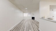 Located at 825 S Hobart Blvd in the heart of Los Angeles, this 2-bedroom, 2-bathroom unit offers a thoughtfully designed single-floor layout. Throughout the space, light-toned luxury vinyl plank flooring provides a clean, contemporary aesthetic that ties each room together seamlessly.

The open kitchen-living area serves as the heart of the unit. The kitchen is outfitted with white shaker cabinetry, quartz countertops, stainless steel appliances including a gas range, microwave, and dishwasher, and a double-basin sink. A pantry provides additional storage. The adjoining living room features a fireplace, built-in display shelves, recessed lighting, a ceiling fan, and a window with vertical blinds that allows natural light to filter in.

Both bedrooms are bright and well-proportioned, with large windows dressed in vertical blinds that invite natural light. The primary bedroom includes a dedicated closet with built-in shelving and hanging rods. The second bedroom is equally versatile and comfortable.

Each bathroom is finished with white vanity cabinetry, marble-look countertops, and a tub-shower combination enclosed by sliding frosted glass doors, all set on matching LVP flooring. The clean, neutral palette throughout the unit creates a bright and welcoming atmosphere.