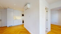 Located at 590 Avenue Outremont in the charming Outremont neighbourhood of Montréal, this thoughtfully designed one-bedroom, one-bathroom unit offers a clean and modern living experience across a single floor. The space is unified by stunning herringbone-pattern hardwood floors that run throughout, lending a timeless elegance to every room.

The living area is bright and open, bathed in natural light through large double-hung windows that frame lush, tree-lined street views — a hallmark of this desirable Montréal neighbourhood. The crisp white walls and recessed lighting keep the atmosphere fresh and airy.

The bedroom is a well-proportioned private retreat, also finished with the same warm herringbone hardwood flooring. Multiple windows invite generous natural light and provide peaceful views of the surrounding greenery, creating a calm and restful ambiance.

The bathroom is finished to a high modern standard, featuring large-format beige floor tiles, a sleek wall-mounted sink, and a full glass-enclosed walk-in shower with ceiling-mounted rainfall and handheld fixtures, complemented by neutral stone-toned wall tiles. The overall design is clean, minimalist, and functional.

A hallway connects the rooms efficiently, completing this well-appointed unit that balances compact, efficient design with refined finishes in one of Montréal's most sought-after residential addresses.