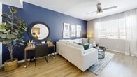 This contemporary 610 square foot apartment offers a harmonious blend of style and functionality. The open-concept layout maximizes space, seamlessly connecting the living room, dining area, and kitchen. The living room is adorned with a striking navy blue accent wall, complemented by a comfortable white sectional sofa and modern artwork. Large windows flood the space with natural light, enhancing the airy feel.

The kitchen boasts crisp white cabinetry, stainless steel appliances, and a spacious island with seating, perfect for casual dining or entertaining. Light wood flooring throughout adds warmth and continuity to the space.

The primary bedroom, measuring 130 square feet, features a plush bed with navy accents and wooden furnishings. Both bedrooms are equipped with ample storage and continue the apartment's color scheme. The bathroom showcases a clean, modern design with a bold blue accent wall and efficient storage solutions.

Thoughtful details such as ceiling fans, recessed lighting, and a private balcony enhance the overall living experience. The apartment's cohesive design, emphasizing blues, whites, and natural wood tones, creates a calming and inviting atmosphere throughout the 610 square feet of living space.