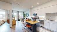 Located on El Cajon Boulevard in San Diego's vibrant North Park neighborhood, this thoughtfully designed one-bedroom, one-bathroom residence maximizes its footprint with a smart, open-concept layout. The combined living, dining, and kitchen area serves as the heart of the home, featuring light wood-tone flooring, recessed lighting, and large windows that invite generous natural light throughout. The kitchen is outfitted with stainless steel appliances including a gas range, built-in microwave, and refrigerator, complemented by white flat-front cabinetry, a tiled backsplash, and a navy island with a butcher block top and seating for two. The living area flows seamlessly to a private balcony through a glass-paned door, offering neighborhood views. The bedroom is a comfortable retreat with a large window, a closet, and additional closet storage, providing practical organization. The bathroom features a floating white vanity, wood-look flooring, and a glass-enclosed walk-in shower with clean tile surround. In-unit laundry adds further convenience. Throughout the residence, modern finishes and a bright, neutral palette create a cohesive and inviting atmosphere.