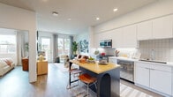 Located on El Cajon Boulevard in San Diego's vibrant North Park neighborhood, this thoughtfully designed one-bedroom, one-bathroom residence maximizes its footprint with a smart, open-concept layout. The combined living, dining, and kitchen area serves as the heart of the home, featuring light wood-tone flooring, recessed lighting, and large windows that invite generous natural light throughout. The kitchen is outfitted with stainless steel appliances including a gas range, built-in microwave, and refrigerator, complemented by white flat-front cabinetry, a tiled backsplash, and a navy island with a butcher block top and seating for two. The living area flows seamlessly to a private balcony through a glass-paned door, offering neighborhood views. The bedroom is a comfortable retreat with a large window, a closet, and additional closet storage, providing practical organization. The bathroom features a floating white vanity, wood-look flooring, and a glass-enclosed walk-in shower with clean tile surround. In-unit laundry adds further convenience. Throughout the residence, modern finishes and a bright, neutral palette create a cohesive and inviting atmosphere.