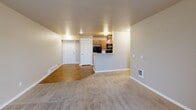 This 2-bedroom, 2-bathroom unit at 3307 E 55th Ave in Spokane, WA offers a well-designed single-floor layout that balances comfort and functionality. The open-concept living area seamlessly connects the dining room, kitchen, and living room, creating a spacious and cohesive gathering space. The kitchen is well-equipped with warm wood cabinetry, light countertops, black appliances including a refrigerator, electric range, microwave, and dishwasher, and durable hardwood-style flooring. A peninsula with a built-in sink adds both workspace and a natural division between the kitchen and living areas. The living room features soft carpeting and a sliding glass door that opens onto a private balcony, inviting natural light and outdoor views. Both bedrooms are carpeted and include natural light from windows, baseboard heating, and closet access — with the primary bedroom offering generous proportions. The two bathrooms feature warm wood vanities with storage, tile-style flooring, and clean, functional finishes. Additional highlights include in-unit laundry, four closets for abundant storage, and a hallway connecting the private spaces. The neutral color palette throughout gives the unit a clean, move-in ready appeal.