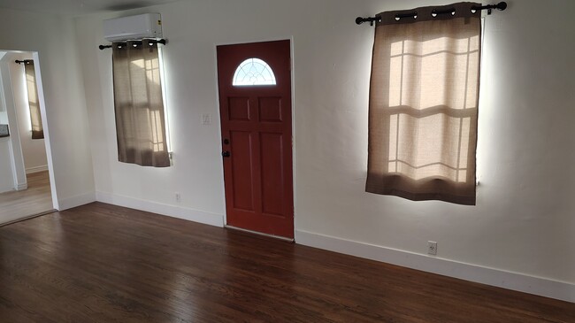 Front Room. New paint, flooring, and curtains throughout the entire home! - 4210 Walnut Grove Ave