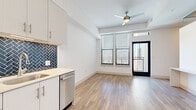 Located at 800 N 2nd St in Phoenix, AZ, this thoughtfully designed 3-bedroom, 1-bathroom unit offers a modern living experience across a single floor. Light wood-style flooring flows consistently throughout, creating a warm and cohesive aesthetic.

The kitchen is a standout feature, showcasing crisp white cabinetry extending to the ceiling, a bold navy herringbone tile backsplash, white quartz countertops, and a full suite of stainless steel appliances including a refrigerator, electric range, over-the-range microwave, and dishwasher.

The three bedrooms are bright and clean, finished with the same wood-style flooring and white walls. The primary bedroom features a built-in closet with shelving, while another bedroom benefits from corner wraparound windows that invite generous natural light and city views.

The bathroom is well-appointed with a tiled tub-shower surround in neutral tones, wood-style flooring, a white vanity with an illuminated mirror, and brushed nickel fixtures throughout.

A hallway connects the living spaces efficiently, and the open living area provides a versatile layout. The overall design is clean and contemporary, well-suited for urban living in the heart of Phoenix.
