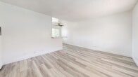 Located at 630 N Cerritos Ave in Azusa, CA, this one-bedroom, one-bathroom unit offers a thoughtfully laid-out single-floor plan designed for comfortable everyday living. Light wood-look flooring runs consistently throughout the space, complementing the crisp white walls and creating a clean, cohesive aesthetic.

The open living area is bright and airy, featuring a textured ceiling, a ceiling fan, and a pass-through window that connects to the kitchen, enhancing the sense of openness. The kitchen is well-appointed with white shaker-style cabinetry extending to the ceiling, light stone-look countertops, a tiled backsplash, a matte black faucet, and a black refrigerator, all contributing to a modern, functional workspace.

The bedroom offers a comfortable footprint, complete with a ceiling fan, a window fitted with blinds that allow natural light while maintaining privacy, and a full-width mirrored sliding closet that adds depth and practicality to the room.

The bathroom is finished in a clean, all-white scheme with white subway tile surrounding the soaking tub and shower combination, a white vanity with brushed nickel fixtures, a wall mirror, and a window for natural ventilation. A hallway connects the main living spaces efficiently, completing this tidy and well-maintained home.