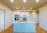 Located at 4770 West Ln in Stockton, CA, this single-floor, three-bedroom, two-bathroom unit offers a thoughtfully designed layout with modern finishes throughout. The open-concept kitchen and living area serves as the heart of the home, anchored by a central island with a double sink and built-in dishwasher. The kitchen is well-appointed with white cabinetry, light countertops, and a full suite of stainless steel appliances, including a refrigerator with ice maker, range, and microwave. Recessed lighting illuminates the space, complementing the warm hardwood-style flooring that runs through the main living areas. The living room benefits from large windows that invite natural light and provide views of the surrounding neighborhood. A dedicated entry area features a glass-paneled door and pendant light fixture. The bedrooms are carpeted for comfort, with the secondary bedrooms offering ample natural light via sliding windows. The primary bedroom includes a sliding closet door for convenient storage. Both bathrooms are clean and functional, each featuring a tub-shower combination with tiled surround, with one bathroom offering a full vanity with under-sink cabinetry and a large mirror. The unit also includes a dedicated closet space, providing additional storage throughout.