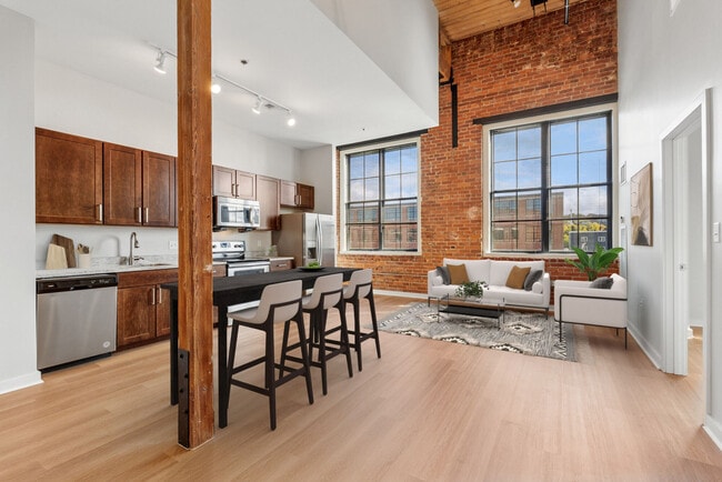 Open-concept loft apartment with high ceilings, oversized windows, and contemporary finishes - Voke Lofts
