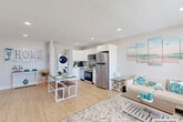 Located at 18801 N Miami Ave in Miami, FL, this single-floor, one-bedroom, one-bathroom residence offers a well-designed open-concept layout that maximizes every square foot. Light wood-tone flooring flows seamlessly throughout, lending warmth and continuity to the entire space.

The living room is bright and inviting, featuring recessed lighting, a large window that fills the room with natural light, and a coastal-inspired aesthetic with neutral tones and aqua accents. It opens directly into the dining area and kitchen, creating a cohesive and functional common space.

The kitchen is outfitted with sleek white cabinetry, a subway tile backsplash, and a full suite of stainless steel appliances, including a refrigerator, range, and built-in microwave. A stacked washer and dryer unit is neatly tucked away within a dedicated closet adjacent to the kitchen, adding exceptional in-unit convenience.

The bedroom is well-proportioned and filled with natural light from a large window with plantation-style blinds. A ceiling fan, built-in closet with louvered doors, and light wood flooring complete the room.

The bathroom showcases floor-to-ceiling marble-look tile, a floating wood-toned vanity with an undermount sink, and a mirrored medicine cabinet, delivering a clean, contemporary finish.