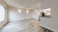 Located at 4328 Berryman Ave in the Mar Vista neighborhood of Los Angeles, this single-floor unit offers a thoughtfully updated interior with a clean, modern aesthetic throughout. The open living area is bright and welcoming, featuring light-toned wood-style flooring, neutral grey walls, and a textured ceiling. A large window fitted with vertical blinds fills the space with natural light and offers views of the surrounding neighborhood. Wall-mounted sconce lighting adds a warm, contemporary touch.

The kitchen is efficiently laid out and well-appointed, showcasing white shaker cabinetry, dark countertops, a stainless steel sink, and a stainless steel gas range with overhead ventilation. A stainless steel refrigerator completes the suite of appliances, and a pendant light over the counter adds a polished finishing detail.

The bedroom is a comfortable retreat with the same wood-style flooring, a sliding-door closet with built-in shelving, a window unit for climate control, and a window with vertical blinds providing natural light.

The bathroom features classic white subway tile surrounding a soaking tub and shower combination, with a small window above for ventilation. The floor is finished in a neutral tile. A stacked washer and dryer unit is also included, adding everyday convenience to this well-maintained space.