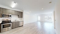 Located at 3057 W Pico Blvd in Los Angeles, this well-appointed 2-bedroom, 2-bathroom unit offers a clean, modern aesthetic throughout. Light-toned hardwood flooring runs seamlessly across the entire space, lending a bright and cohesive feel to every room.

The open-plan living and kitchen area serves as the heart of the home. The kitchen is outfitted with wood-grain cabinetry extending to the ceiling for ample storage, white countertops, and a full suite of stainless steel appliances including a refrigerator, gas range, microwave, and dishwasher. The adjacent living area is generously sized, featuring recessed lighting and windows that invite natural light.

Both bedrooms are comfortably scaled, with crisp white walls and continued hardwood flooring. The spacious primary bedroom includes sliding mirrored closet doors and direct access to a private balcony, offering outdoor views of the surrounding neighborhood. The second bedroom also features mirrored closet doors and a bright window with vertical blinds.

Each of the two bathrooms maintains the same modern sensibility, with wood-toned vanities, white countertops, and full tub-shower combinations with built-in shelving. A dedicated laundry room houses a stacked washer and dryer unit for added convenience. The hallway and closet provide practical additional storage throughout.