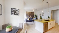 Located at 1001 Frio St in Houston, TX, this well-appointed one-bedroom, one-bathroom unit offers a thoughtfully designed open-concept layout that maximizes every square foot. Light wood-style flooring flows seamlessly throughout, complementing the bright, white walls that create a clean and airy ambiance.

The kitchen is a standout feature, showcasing bold yellow quartz countertops that extend across a peninsula with bar seating — ideal for casual dining. White shaker cabinetry reaches toward the ceiling for ample storage, while stainless steel appliances, including a refrigerator, microwave, and range, add a sleek, modern finish. Pendant lighting above the peninsula enhances the kitchen's contemporary character.

The open living area benefits from natural light streaming through a glass door, lending the space a bright, welcoming feel. A ceiling fan adds comfort, and the layout accommodates both a dining area and a comfortable living room with ease.

The bedroom offers a quiet retreat with two windows that invite natural light, light flooring, and a dedicated closet for storage.

The bathroom is finished with large-format white subway tile in the tub surround, a floating vanity with matching yellow quartz countertop, and light wood-style flooring, maintaining a cohesive design palette throughout the home.