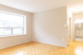 Located at 1061 Seneca Ave in Mississauga, Ontario, this 2-bedroom, 1-bathroom unit offers a practical and well-organized single-floor layout. The galley-style kitchen has been thoughtfully updated with light grey cabinetry, granite-look countertops, white tile backsplash, and large-format tile flooring. It is equipped with a double stainless steel sink, a white electric range, and a full-size refrigerator, with ample upper and lower cabinet storage throughout. A window at the end of the kitchen allows natural light to flow into the space. Both bedrooms feature warm parquet wood flooring and neutral white walls. The primary bedroom is generously sized and includes a built-in closet with bi-fold doors, a baseboard heater, and a window overlooking a green outdoor area. The second bedroom also benefits from parquet flooring and clean, bright walls. The living room is well-lit by a large picture window that frames a view of the surrounding neighbourhood streetscape. The bathroom is finished with white subway tile surrounding a full bathtub and shower combination. A hallway and entrance area connect the rooms, completing this compact yet efficiently designed home.