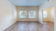 This Hollywood apartment, located at 1851 Ivar, unit 309, offers a well-planned 750 square foot layout. The space comprises one bedroom, one bathroom, a living room, kitchen, hallway, and three closets, all on a single floor. The primary bedroom is particularly spacious at 190 square feet, providing ample room for relaxation and storage.

The apartment features contemporary finishes throughout, with sleek wood-look flooring in the main living areas and bedroom. Large windows in multiple rooms allow for abundant natural light, creating a bright and airy atmosphere. The living room is open and inviting, perfect for entertaining or relaxing.

The kitchen, while compact, is efficiently designed with white cabinetry, contrasting black appliances, and a practical galley layout. It includes a gas range, refrigerator, and ample counter space for meal preparation. The bathroom, though not pictured, likely continues the modern aesthetic of the rest of the apartment.

Ceiling fans in several rooms provide additional comfort and air circulation. The neutral color palette of white walls and light-toned flooring offers a blank canvas for personal decor styles. Overall, this apartment combines functionality with contemporary design, making it an attractive option in the heart of Hollywood.