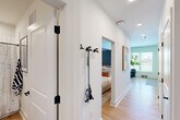Located at 65 Middle River Rd in Chattanooga's North Shore area, this one-bedroom, one-bathroom residence offers a clean, modern aesthetic throughout. Light wood flooring flows consistently across the single-floor layout, lending warmth and visual continuity between spaces.

The living room serves as the social heart of the home, featuring a two-tone accent wall in gray, large windows that draw in natural light and provide outdoor views, and ample room for a full seating arrangement. The bedroom is an intimate retreat accented by a bold navy-blue wall, a ceiling fan, and a dedicated closet with a sliding door, offering a calm and stylish atmosphere.

The bathroom is finished with crisp white subway tile in the tub-shower surround, matte black fixtures, and warm wood-toned flooring — a cohesive blend of contemporary and classic design. The hallway connects the spaces efficiently and includes wall hooks for convenient everyday storage.

The kitchen and an in-unit laundry area round out the layout, providing practical functionality without compromising the home's overall streamlined character. Recessed lighting throughout and a neutral white palette keep the interiors feeling bright and open. This thoughtfully laid-out residence balances style and efficiency in every room.