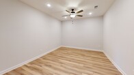 Located at Legacy Park Trail in Burlington, NC, this 2-bedroom, 2-bathroom residence offers a clean, modern aesthetic throughout its single-floor layout. Light wood-style flooring flows through the main living areas, complemented by crisp white walls and recessed lighting with ceiling fans in multiple rooms, creating a bright and airy atmosphere.

The kitchen is well-appointed with warm taupe cabinetry, white quartz countertops, a classic subway tile backsplash, and stainless steel appliances including a dishwasher. The open layout connects seamlessly to the living area, making it ideal for everyday living and entertaining.

The primary bedroom is generously sized, featuring plush carpeting, a ceiling fan, and access to a private balcony that overlooks the landscaped community grounds. The second bedroom also features carpet flooring, a ceiling fan, a large window with natural light, and a double-door closet for ample storage.

Both bathrooms are clean and functional — one features wood-style flooring with a full tub-shower combination, while the second offers a similarly efficient layout. The private balcony provides pleasant outdoor views of the surrounding community with mature trees and open sky. This residence combines practical design with comfortable, contemporary finishes throughout.