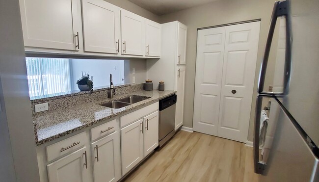 Renovated kitchen with stainless steel appliances and granite countertops - Summerfield Apartments