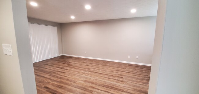 As you enter, to your right is a large living room that leads to the private backyard patio. - 920 Pine Oak Trl