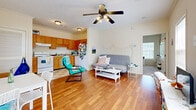 This single-story, one-bedroom, one-bathroom unit at Savannah Square Apartments in Auburn, Alabama offers a practical and comfortable layout designed to maximize its well-proportioned footprint. The open-concept living and kitchen area forms the heart of the unit, where warm hardwood-style flooring extends throughout and a ceiling fan with integrated lighting overhead adds both function and character. Two windows along the front wall flood the living area with natural light, creating a bright and welcoming atmosphere. A dedicated dining area sits adjacent to the main entrance, offering a convenient space for everyday meals.

The kitchen features warm oak cabinetry with ample upper and lower storage, white appliances including a range and refrigerator, and a checkered tile floor that adds a classic touch. The bedroom is generously sized with plush carpeting, cream-toned walls, and a window that continues the unit's emphasis on natural light, providing a calm and restful environment. The bathroom includes a tub-shower combination with tile surround, an oak vanity, and matching checkered flooring that ties cohesively to the kitchen's aesthetic. Overall, the unit presents a clean, functional design well-suited for comfortable everyday living.
