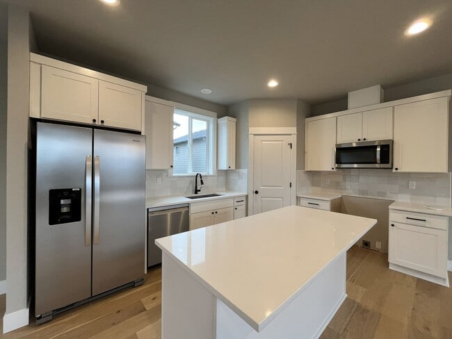 Building Photo - Brand New Spacious and Light-Filled Condo Offering an Open Layout, Island Kitchen, and Outdoor Deck