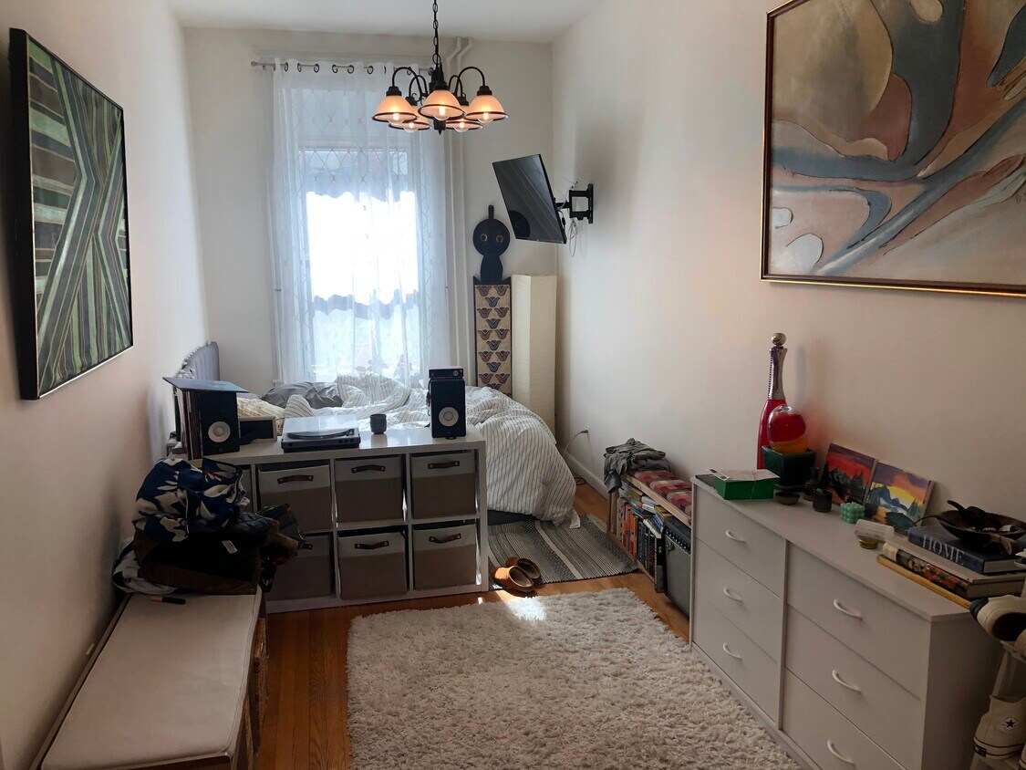 Bed area left of apt entry/exit door - 104 7th St