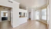 This 750 square foot apartment in Plano, Texas, offers a compact yet functional living space. The unit features two bedrooms, including a primary bedroom of 160 square feet, and three bathrooms, providing ample privacy and convenience for residents. The single-floor layout maximizes space efficiency.

The kitchen is a standout feature, showcasing dark wood cabinetry contrasting with light countertops. It comes fully equipped with modern appliances, including a refrigerator, dishwasher, and electric range. A tiled backsplash adds a touch of style, while the open design allows for easy interaction with adjacent living areas.

Bathrooms are designed with practicality in mind, featuring white fixtures, tiled surrounds, and contemporary vanities. The inclusion of both tub and shower options caters to different preferences. A dedicated laundry area with full-sized appliances adds to the unit's convenience.

Throughout the apartment, light-toned wood-look flooring creates a sense of continuity and brightness. Large windows in the bedrooms and living areas allow for ample natural light, enhancing the feeling of spaciousness. Neutral wall colors provide a blank canvas for personalization.

The overall design emphasizes functionality without compromising on style, making efficient use of the available square footage. Crown molding and ceiling fans in some rooms add subtle elegance to the space. This apartment offers a comfortable and modern living environment in a prime Plano location.