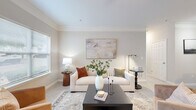 Located at 2090 Columns Dr in Cumming, Georgia, this well-appointed two-bedroom, two-bathroom residence offers a thoughtfully designed single-floor layout. The inviting living room features neutral tones, crown molding, and natural light from large windows, creating a bright and welcoming atmosphere. The galley-style kitchen is well-equipped with stainless steel appliances, white shaker cabinetry with matte black hardware, light quartz countertops, and wood-look flooring that adds warmth to the functional space. The spacious primary bedroom features plush carpet, a ceiling fan, and a window with outdoor views, complemented by a generous walk-in closet with wire shelving. The second bedroom also offers comfortable proportions, its own closet access, and proximity to the second full bathroom. Both bathrooms are finished in clean white tile with tub-shower combinations and updated vanities. A dedicated laundry room houses a full-size washer and dryer with overhead wire shelving for additional storage. Throughout the home, a consistent neutral color palette and clean finishes contribute to a cohesive, modern aesthetic that is both practical and comfortable.