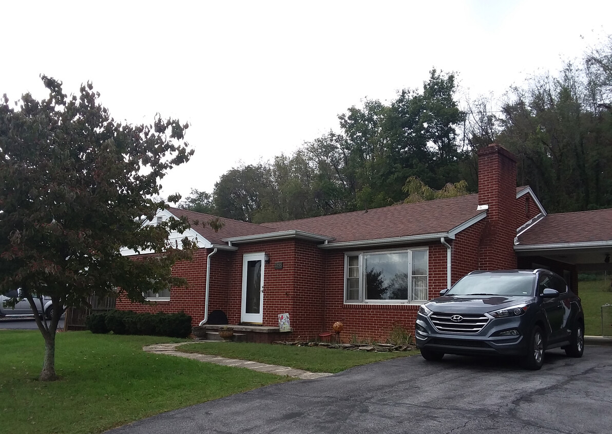 Driveway has covered carport and room for two more cars. - 1255 Culbert Dr