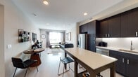Located at 3560 Rambla Pl in Santa Clara, California, this contemporary single-floor residence showcases a thoughtfully designed open-concept layout with modern finishes throughout. The kitchen is a standout feature, equipped with dark espresso cabinetry extending to the ceiling, stainless steel appliances including a gas range and built-in microwave, crisp white quartz countertops, and a central island with bar seating — ideal for both cooking and casual dining. Light wood-style flooring runs through the main living areas, enhancing the bright, airy feel created by recessed lighting and natural light from multiple windows. The living room offers generous space for relaxing, anchored by neutral tones and large windows that allow views of the surrounding area. The bedrooms feature plush carpeting, bold accent walls, and large windows with blinds and draping curtains that provide both light control and privacy. One bedroom includes convenient access to a walk-in closet. The bathrooms are finished with dark vanity cabinetry, white quartz countertops, large mirrors, and light wood-style flooring, with one bathroom featuring a full soaking tub. The overall design palette — combining dark cabinetry, neutral walls, and light flooring — delivers a cohesive, sophisticated aesthetic throughout the residence.
