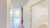 Located at 112 Garden St in South Burlington, Vermont, this thoughtfully designed studio offers a clean, contemporary living experience across a single, efficiently organized floor. The open-plan kitchen and living area serves as the heart of the space, bathed in natural light from large windows that frame pleasant views of surrounding trees and the Vermont landscape. The kitchen is well-appointed with white shaker-style cabinetry, dark countertops, and a full suite of stainless steel appliances including a refrigerator, microwave, dishwasher, and range. A wall-mounted mini-split unit provides climate control, complemented by baseboard heating throughout. Light-toned hardwood flooring flows seamlessly through the living area, adding warmth and continuity to the open layout. Recessed lighting enhances the bright, airy ambiance. The bathroom features a step-in shower with built-in shelving, a white vanity, tile flooring, and accessibility-friendly grab bars, combining practicality with clean design. Crisp white walls throughout the space create a neutral, versatile backdrop well-suited for a variety of décor styles. This studio offers a modern, move-in-ready living environment in a convenient South Burlington location.