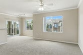 Located at 39415 Ardenwood Way in Lake Elsinore, CA, this single-story 2-bedroom, 2-bathroom home offers a well-organized and comfortable layout. The interior greets you with a hallway framed by elegant arched architectural details and crown molding that carries throughout the living areas, lending a refined touch to the neutral, light-toned palette.

The open-concept living and dining area is bright and airy, with large windows and a sliding glass door that fill the space with natural light and provide views of the surrounding community. A ceiling fan with integrated lighting adds both style and functionality to this generous main living area, which opens directly onto a private patio.

The kitchen features warm wood-toned cabinetry, light stone countertops with a breakfast bar peninsula, black appliances including a range, microwave, and refrigerator, and wood-style flooring. A pantry provides additional storage, and an in-unit washer is conveniently included.

Both bedrooms are carpeted and finished in warm neutral tones, offering a calm retreat. The primary bedroom includes a walk-in closet with wire shelving systems. The bathrooms are clean and functional, with one featuring a tub/shower combo, wood-toned vanity cabinetry, and light stone countertops. Three total closets ensure ample storage throughout the home.