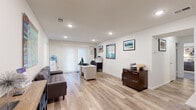 Located at 1605 Plaza Dr in Woodbridge, NJ, this single-floor, 2-bedroom, 2-bathroom residence offers a thoughtfully designed layout with a clean, modern aesthetic. Light wood-style flooring runs through the main living areas and hallways, complemented by recessed lighting and crisp white walls that create a bright, welcoming ambiance throughout.

The open living area flows seamlessly and features a sliding glass door with vertical blinds that allows natural light to pour in. The galley-style kitchen is well-equipped with warm wood cabinetry, granite countertops, a tile backsplash, and stainless steel appliances including a gas range and refrigerator. A cozy dining nook with a window sits just beyond the kitchen.

The spacious primary bedroom features plush carpeting and a large window, offering a comfortable, restful retreat. The second bedroom is equally well-sized with carpeting and natural light. Both bathrooms are neatly finished — one with a glass-enclosed shower and the other with a granite-topped vanity and tile flooring.

Additional highlights include six closets for abundant storage, a dedicated laundry area, and a utility room. The layout also accommodates a versatile living space currently configured as an office area, making this residence both practical and adaptable.
