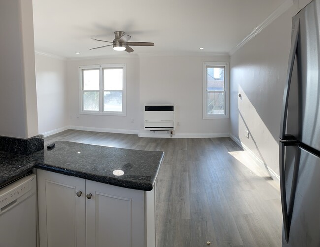 Spacious living room with ceiling fan, window A/C unit and heating unit - 358 22nd St