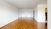 Located at 19 Rosemount Drive in Toronto, this 2-bedroom, 1-bathroom unit offers a functional and comfortable layout across a single floor. The living area is generously sized and bathed in natural light from large windows that frame views of surrounding trees and the neighbourhood beyond. Warm-toned parquet flooring runs throughout the living spaces and bedrooms, adding character and a timeless appeal.

The kitchen has been updated with white shaker-style cabinetry, dark countertops, a grey subway tile backsplash, and stainless steel appliances including a full-size refrigerator and dishwasher. Light tile flooring completes the clean, modern aesthetic.

Both bedrooms are well-proportioned, featuring the same rich parquet flooring, bright windows with outdoor views, baseboard heating units, and sliding double-door closets for ample storage. The primary bedroom offers a comfortable footprint with natural light.

The bathroom is finished with neutral large-format wall tiles in the tub surround, a full soaker tub, and clean white fixtures, creating a simple and tidy space.

A hallway connects the rooms efficiently, and the overall unit presents a bright, clean, and move-in ready atmosphere throughout.