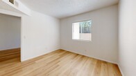 Located at 4040 E Fort Lowell Rd in Tucson, Arizona, this efficient one-bedroom, one-bathroom unit is thoughtfully laid out across a single floor. Light wood-style flooring runs throughout the entire space, creating a clean, cohesive look that ties each room together.

The living area features crisp white walls and a textured ceiling, offering a bright and neutral backdrop. It flows naturally toward the galley-style kitchen, which is equipped with warm wood cabinetry both above and below the counter, light-toned countertops, a stainless steel sink, and black appliances including a refrigerator and electric range — providing all essential cooking amenities in a compact, functional layout.

The bedroom is a well-proportioned, private retreat with white walls, a textured ceiling, and a window fitted with blinds that invites natural light while maintaining privacy. A dedicated closet adds practical storage to the room.

The bathroom continues the consistent wood-style flooring and includes a full tub-shower combination with a white surround, a toilet, and a wood-toned vanity with a sink — clean and functional in design.

Throughout the unit, the consistent use of light tones, wood flooring, and white walls creates a simple, tidy ambiance well-suited to efficient living in the heart of Tucson.